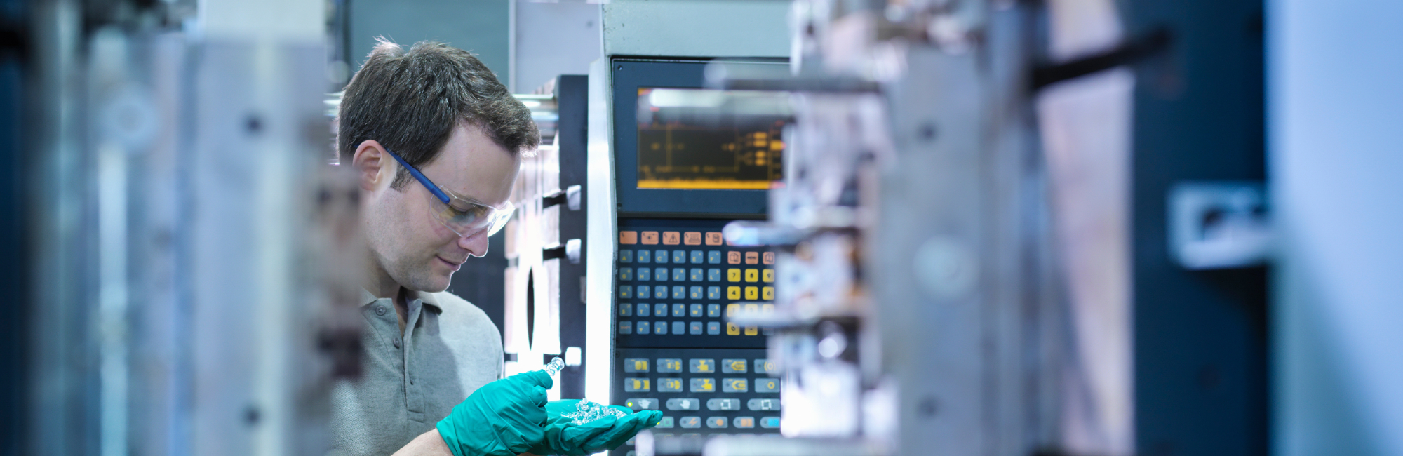 Engineer checking parts at a press